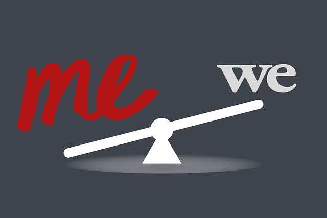 A conceptual illustration of narcissism represented by a seesaw, with the word "Me" in bold red weighing down one side and the word "We" in lighter gray on the other, signifying the imbalance between self-interest and collective interest.