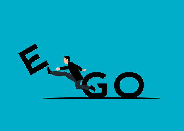 An illustration of a person kicking away the letter "E" from the word "EGO," symbolizing overcoming ego-driven behavior and fostering self-awareness.