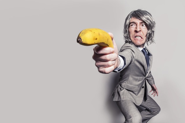 A humorous depiction of a businessman holding a banana like a gun, symbolizing the quirky and unexpected challenges entrepreneurs face