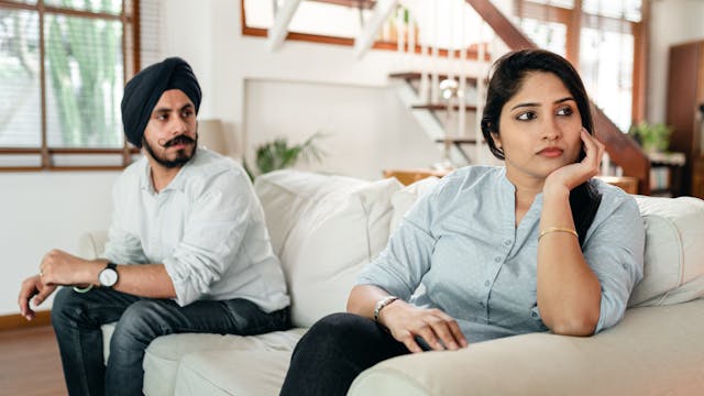 An illustration showing two individuals sitting apart in silence, emphasizing the emotional distance and psychological impact of the silent treatment.